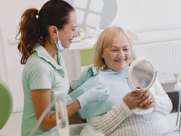 Senior patient delighted with her full mouth rehabilitation result